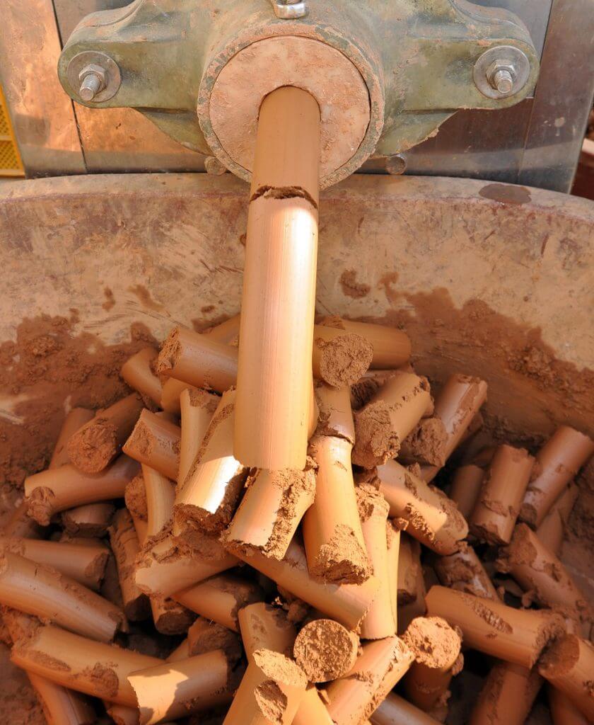 pressing red mountain clay to seal the bamboo sleeves with sea salt