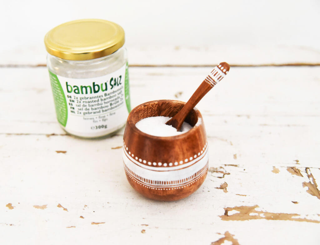 2x roasted bamboo salt in a bowl with packaging from Bambu® Salz