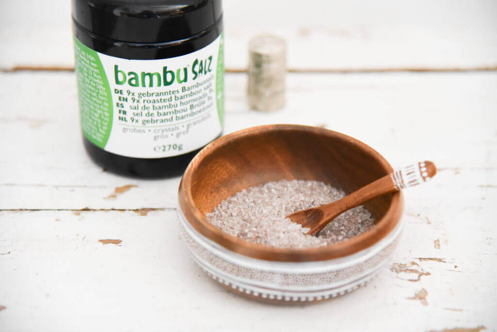 9x roasted bamboo salt crystals in a bowl with packaging from Bambu® Salz